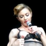 MADONNA shows her NIPPLE while teasing a concert audience!